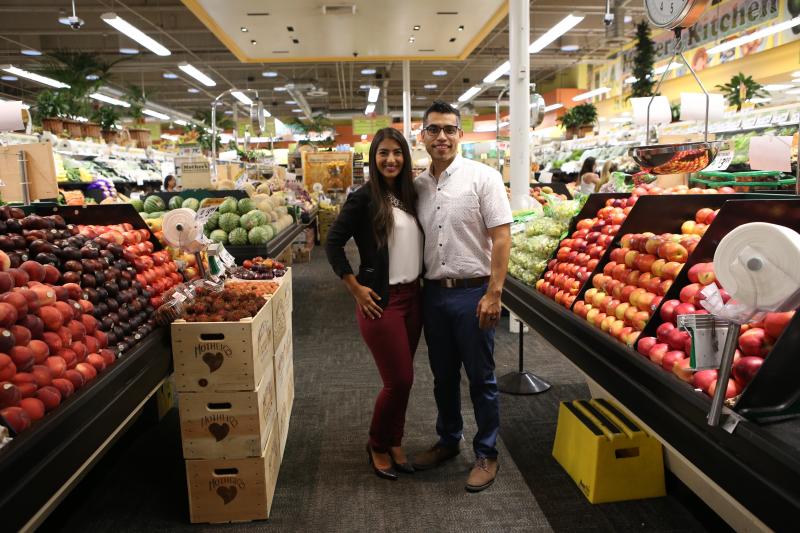 two people standing in produce aisle