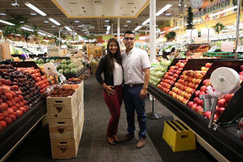 woman and man standing in produce aisle
