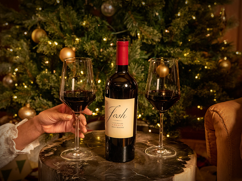 Bottle of Josh Cellars wine in front of a Christmas tree
