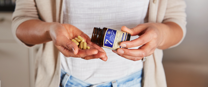 woman holding pills in her hand